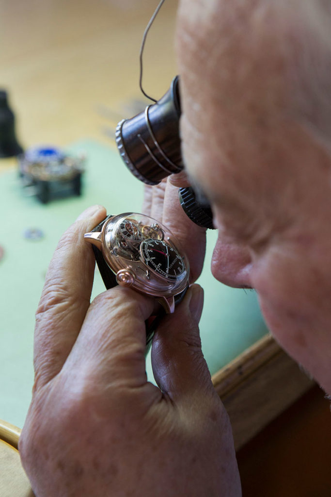 Closeup view of Philippe Dufour examining the Cu29 timepiece